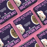 Multiple packages of Lypid Kitchen BBQ Pork Bao on a pink background